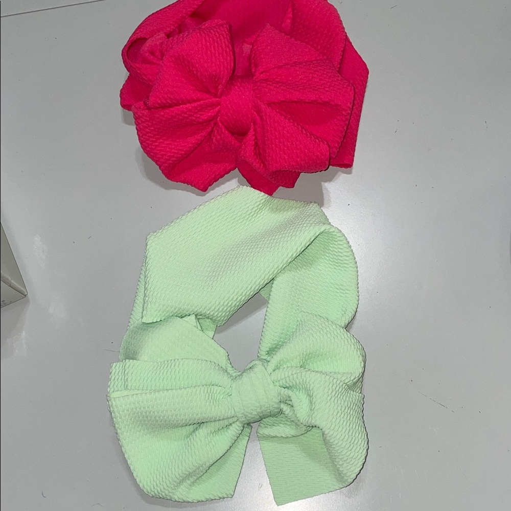 Two stretch headbands with large bows, one bright pink, one mint green-NWOT